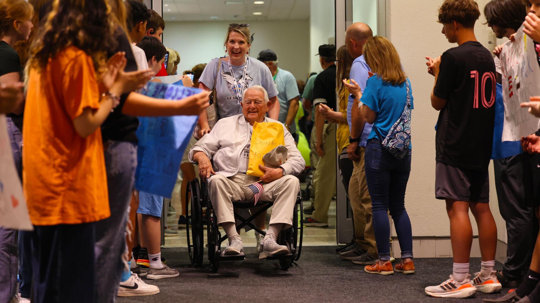Veteran goes through final part of crowd at Honor Flight Return Home.JPG